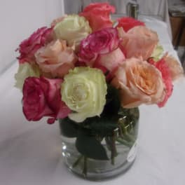 Bouquet of multicolored roses in a clear glass vase
