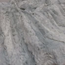 Close-up of a light gray faux fur fabric with a shaggy texture.