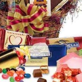 Gift basket with assorted chocolates, candy, and a striped bow