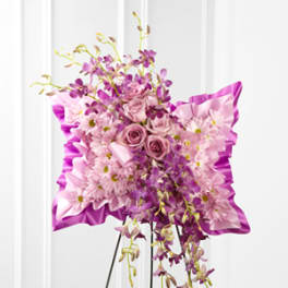 Pink and purple floral standing spray on an easel