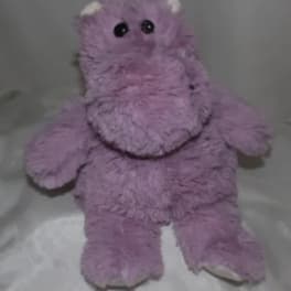 Purple plush teddy bear with black eyes and white paws