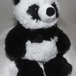Plush panda bear sitting upright on a light background