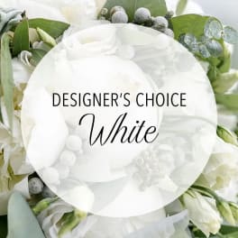 White floral arrangement with green foliage and a "Designer’s Choice White" label