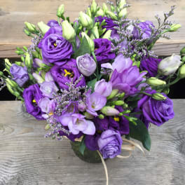 Purple and lavender bouquet with lisianthus in a vase