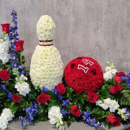 Floral display with a white bottle shape and a red round floral piece