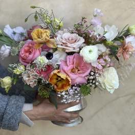Mixed pastel bouquet in a silver vase with roses and tulips