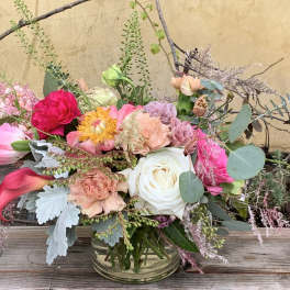 Mixed bouquet in a clear glass vase with pink, white, and peach flowers