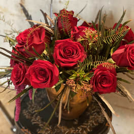 Bouquet of red roses in a gold vase