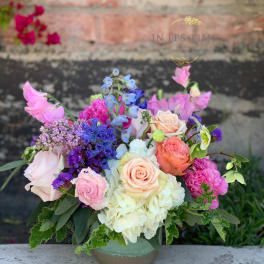 Colorful mixed bouquet in a low ceramic vase