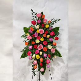 Tall standing spray of multicolored roses on an easel