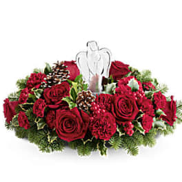 Red rose and carnation centerpiece with a white angel topper
