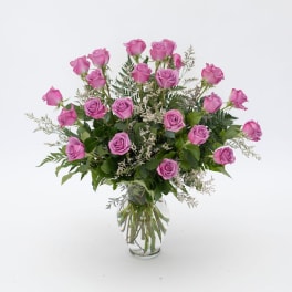 Pink roses arranged in a clear glass vase