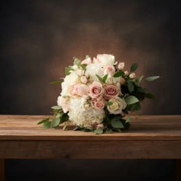Bouquet of blush and white roses with hydrangeas and greenery