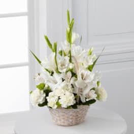 White floral arrangement in a woven basket