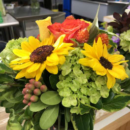 Bouquet with yellow sunflowers, a red rose, and green hydrangea