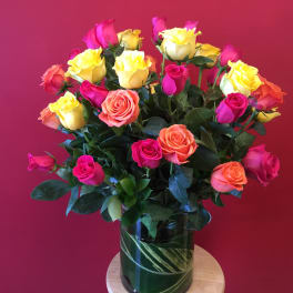 Bouquet of multicolored roses in a glass vase
