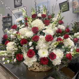 Large basket arrangement of red roses and white flowers