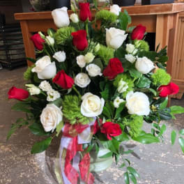 Bouquet of red and white roses with green accents and ribbon