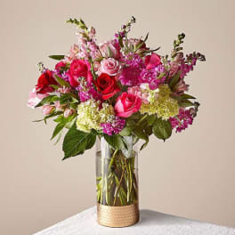 Pink and red rose bouquet in a clear glass vase