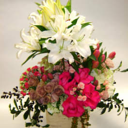 Mixed bouquet of white lilies and pink roses in a box