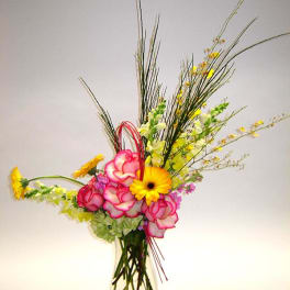 Tall vase arrangement with pink roses and yellow gerbera daisies