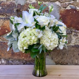 White floral bouquet in a clear glass vase