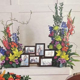 Colorful floral display framing a set of family photo frames