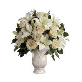 White lilies and cream roses arranged in a vase