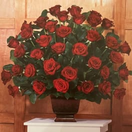 Large arrangement of red roses in a dark vase