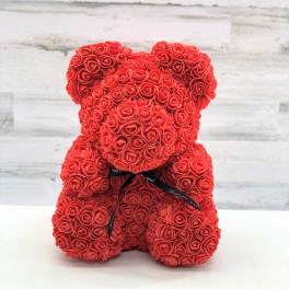 Red rose teddy bear with a black ribbon bow