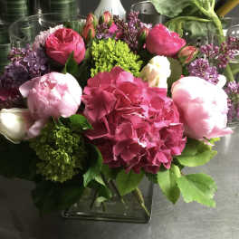 Pink and white floral arrangement in a glass vase