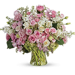 Pink and white rose bouquet in a clear glass vase