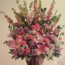 Pink and lavender floral arrangement in a decorative vase