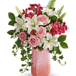 Pink roses and white lilies in a pink vase