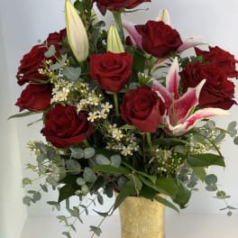 Red roses and pink lilies in a gold vase