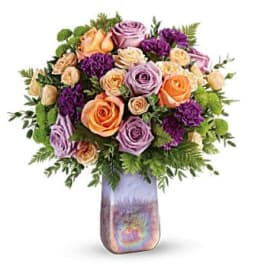 Mixed roses and purple blooms in a iridescent vase
