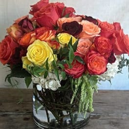 Mixed roses in a clear glass vase