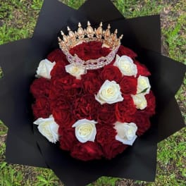 Bouquet of red and white roses with a jeweled crown on top