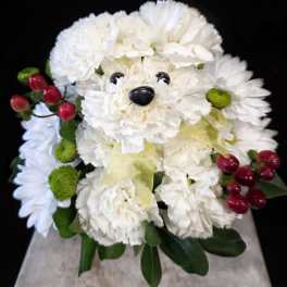 White flower arrangement shaped like a teddy bear with red berry accents