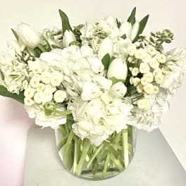 White floral bouquet in a clear glass vase