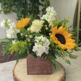 Sunflower and white floral arrangement in a wooden box