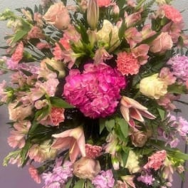 Large pink and pastel mixed flower arrangement with lilies and carnations
