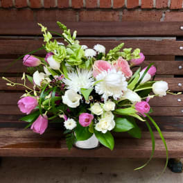 Pink and white mixed flower arrangement in a white vase