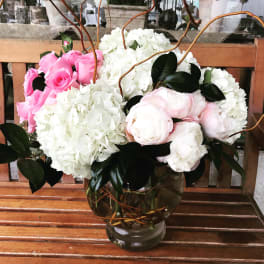 Pink roses and white hydrangeas in a glass vase