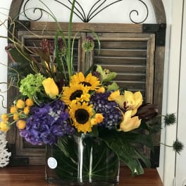 Colorful mixed flower arrangement in a clear glass vase