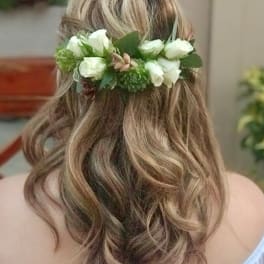 Woman wearing a white floral hair crown in her hair