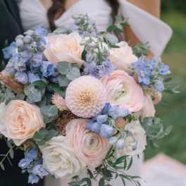 Wedding bouquet of blush, white, and blue flowers