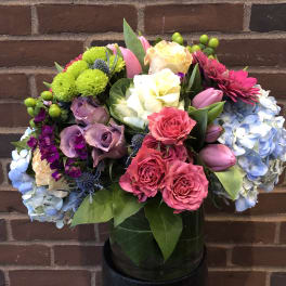 Mixed bouquet with roses, tulips, hydrangeas, and chrysanthemums in a vase
