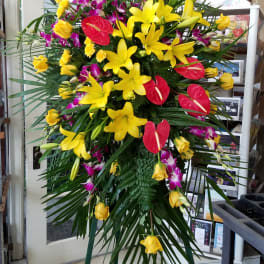 Tall standing floral spray with yellow lilies, red anthuriums, and purple orchids