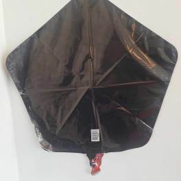 Black star-shaped foil balloon against a white background